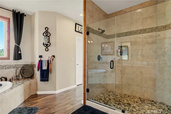 a bathroom with a tub a sink and a shower