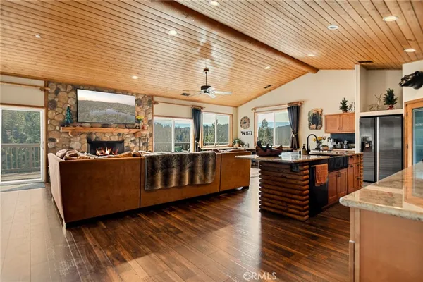 a living room with lots of wooden furniture and a table
