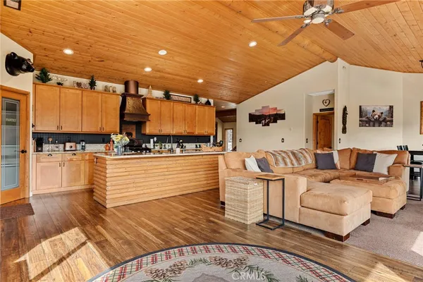 a living room with furniture and kitchen view