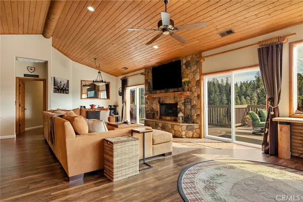a living room with fireplace furniture and a flat screen tv