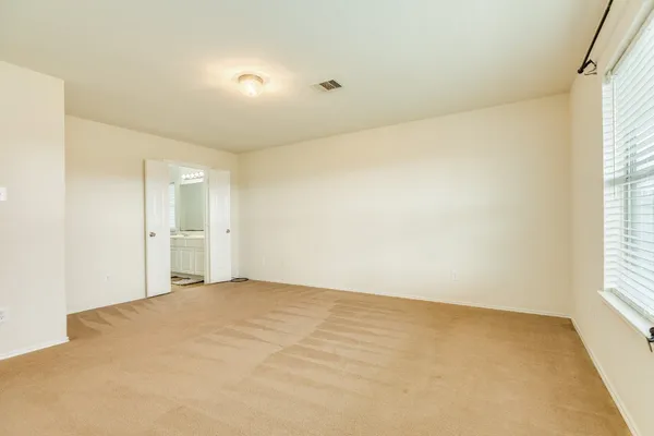 a view of an empty room and a window