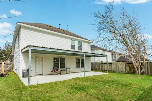 a view of a house with a yard and sitting area