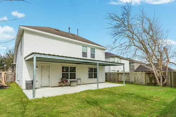 a view of a house with a yard and sitting area