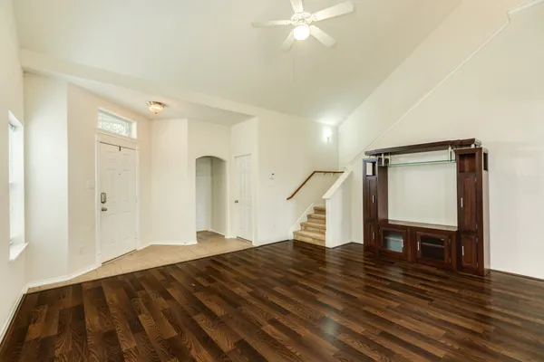 a view of empty room with wooden floor