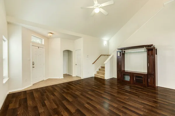 a view of empty room with wooden floor