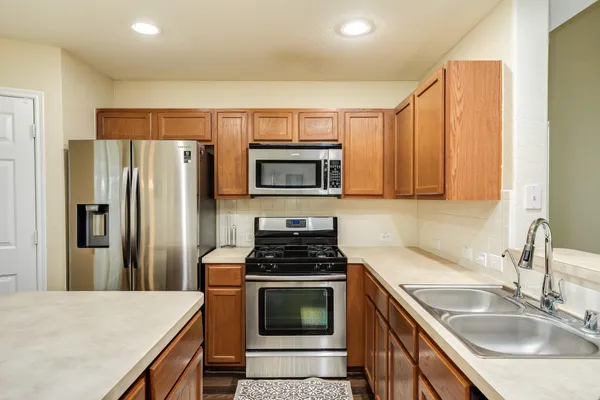 a kitchen with a sink stove and refrigerator