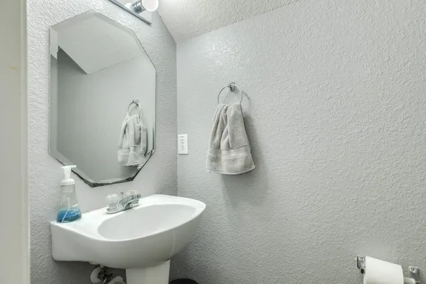 a bathroom with a sink and mirror