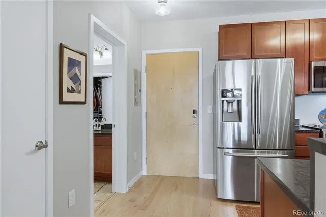 a metallic refrigerator freezer sitting in a kitchen