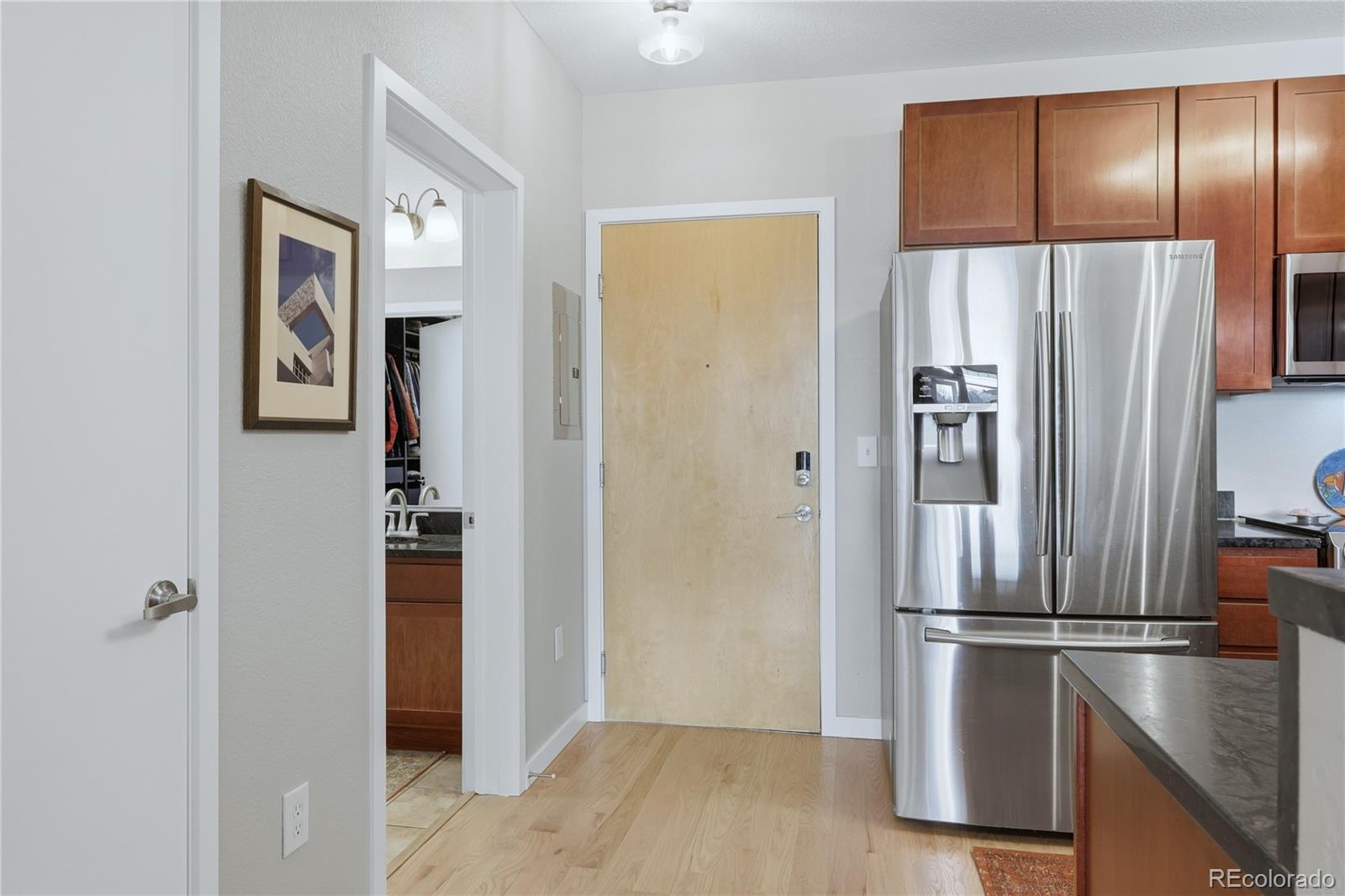 3101 Blake Street, Unit 201 Denver, CO 80205 - Photo 9 of 29 a metallic refrigerator freezer sitting in a kitchen