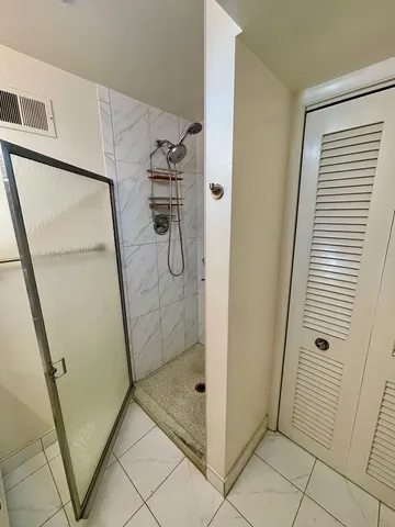 a bathroom with a glass shower door