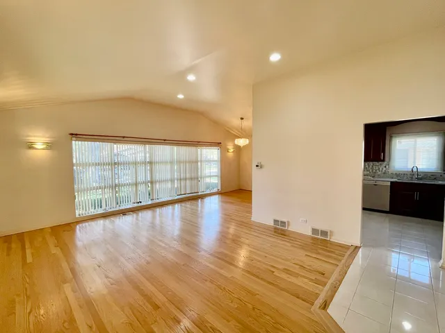 a view of wooden floor and windows in a room