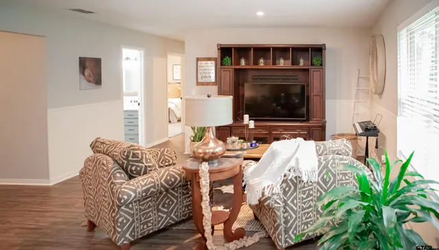 a living room with furniture fireplace and potted plant