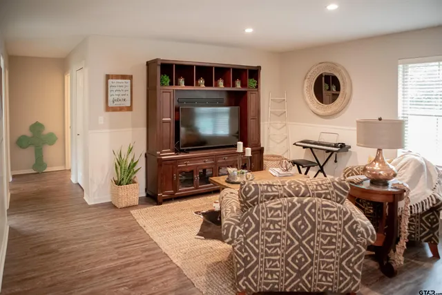 a living room with furniture and a flat screen tv