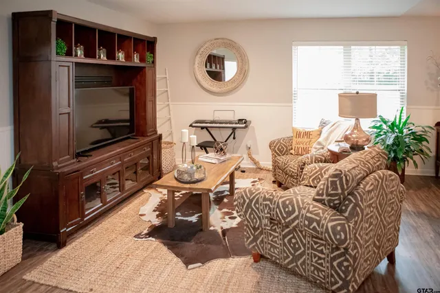 a living room with furniture and a flat screen tv