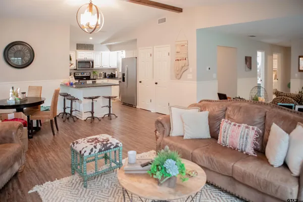 a living room with furniture kitchen view and a table
