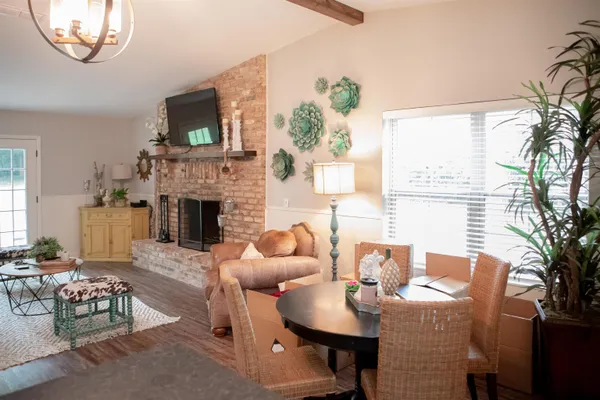 a living room with furniture a fireplace and a flat screen tv