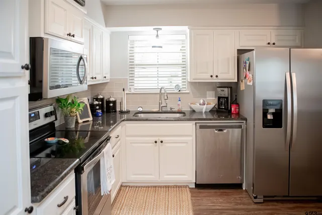 a kitchen with a refrigerator and a sink