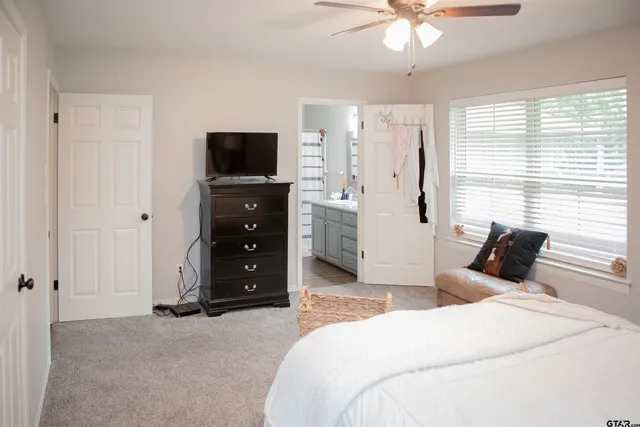 a bedroom with a bed and a television