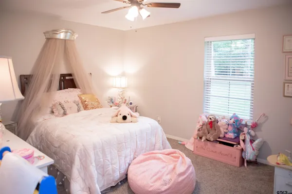 a bedroom with bed and a window