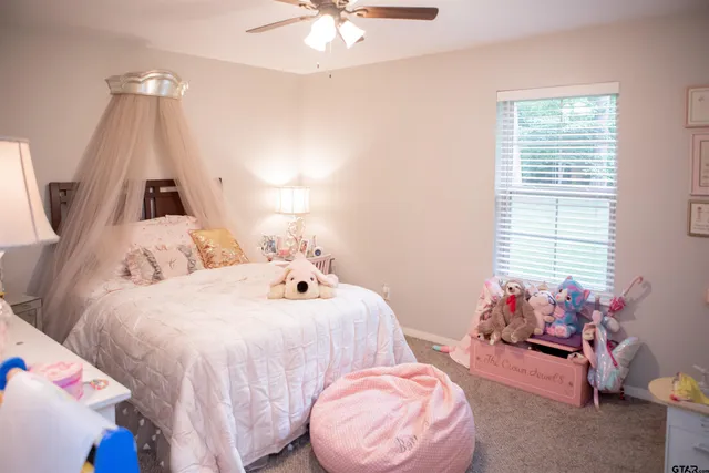 a bedroom with bed and a window