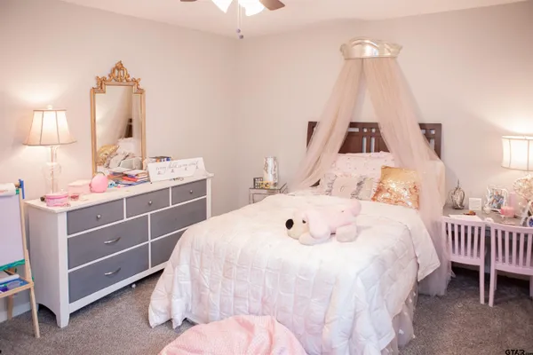 a bedroom with a bed and a mirror