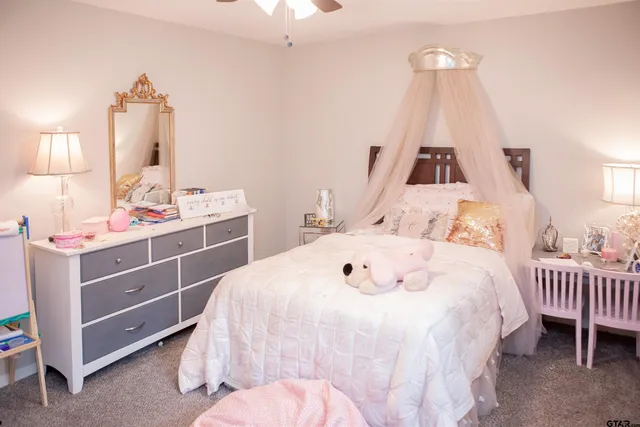 a bedroom with a bed and a mirror