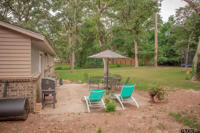 a view of a chairs and table in the patio