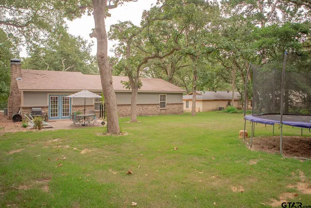 a view of a house with a yard porch and sitting area