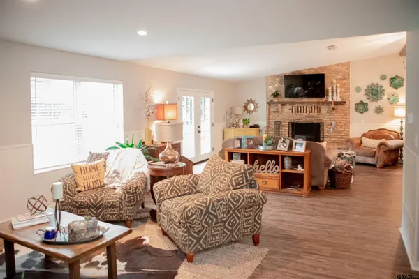 a living room with fireplace furniture and a flat screen tv