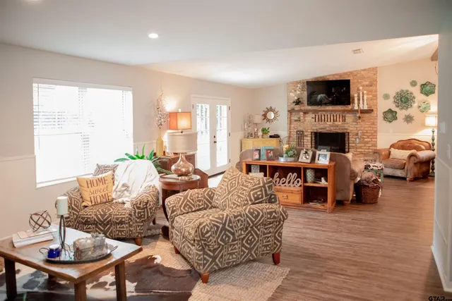 a living room with fireplace furniture and a flat screen tv