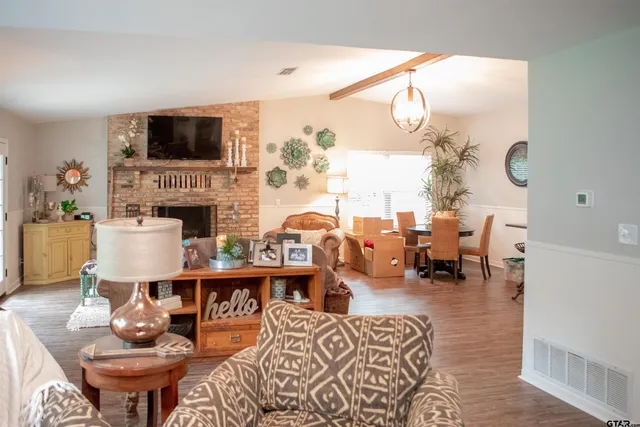 a living room with fireplace furniture and a flat screen tv