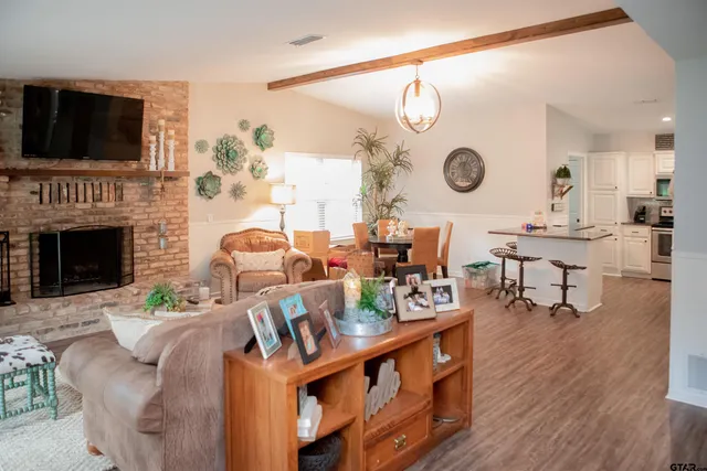 a living room with fireplace furniture and a flat screen tv