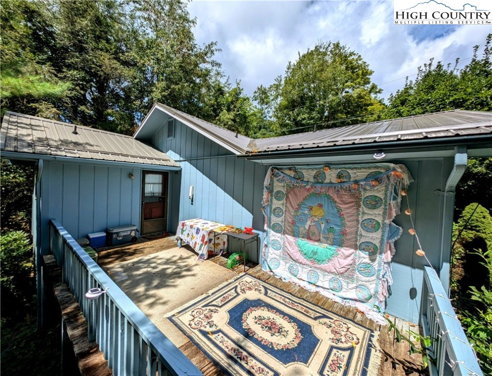 247 Old Bristol Road Boone, NC 28607 - Photo 3 of 5 a view of a patio with table and chairs with wooden floor and fence
