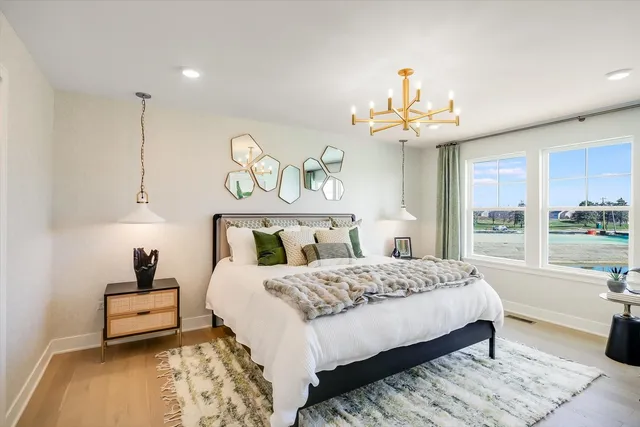 a bedroom with a bed and a chandelier
