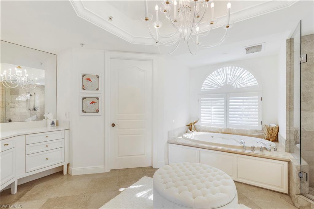 700 La Peninsula Boulevard, Unit 404 Naples, FL 34113 - Photo 23 of 43 a bathroom with a sink a toilet and a bathtub