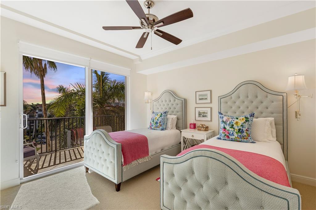 700 La Peninsula Boulevard, Unit 404 Naples, FL 34113 - Photo 25 of 43 a spacious bedroom with a bed and a large mirror