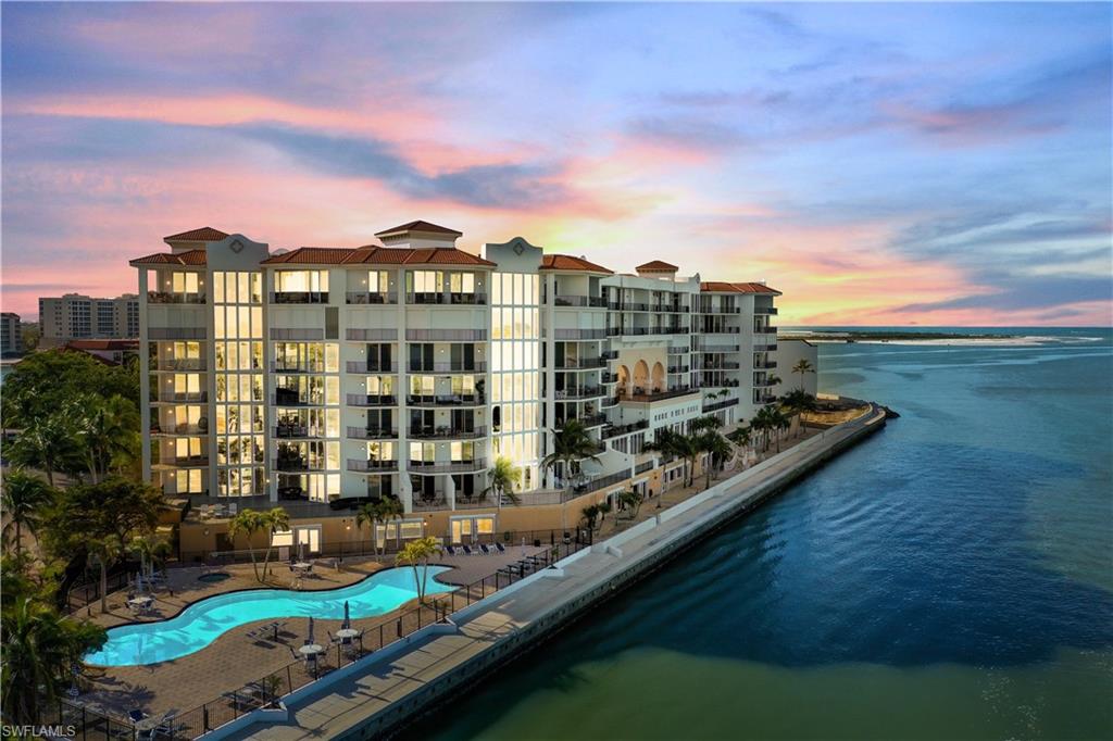 700 La Peninsula Boulevard, Unit 404 Naples, FL 34113 - Photo 37 of 43 a view of a lake with building in front of it