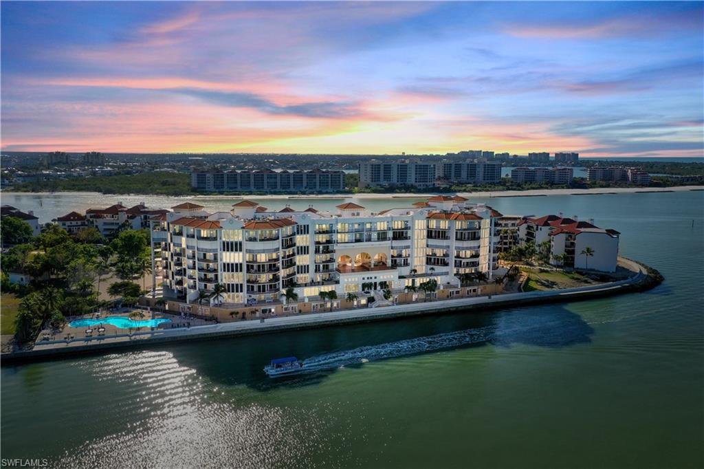 700 La Peninsula Boulevard, Unit 404 Naples, FL 34113 - Photo 40 of 43 a view of a lake with a car parked