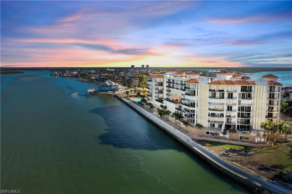 700 La Peninsula Boulevard, Unit 404 Naples, FL 34113 - Photo 41 of 43 a view of a lake with city