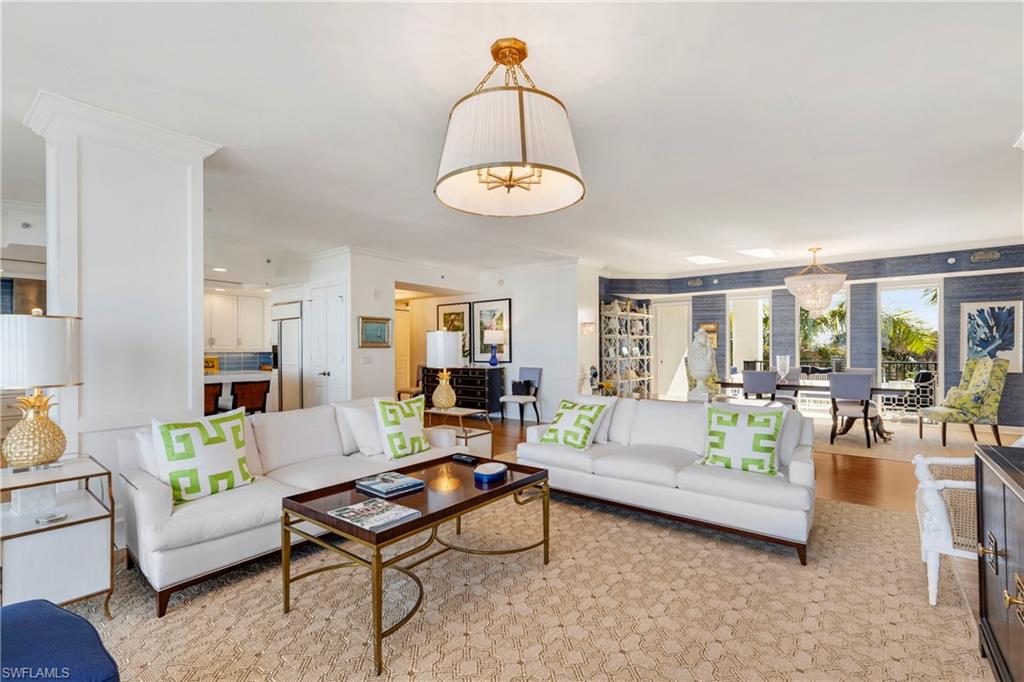 700 La Peninsula Boulevard, Unit 404 Naples, FL 34113 - Photo 10 of 43 a living room with furniture and a wooden floor
