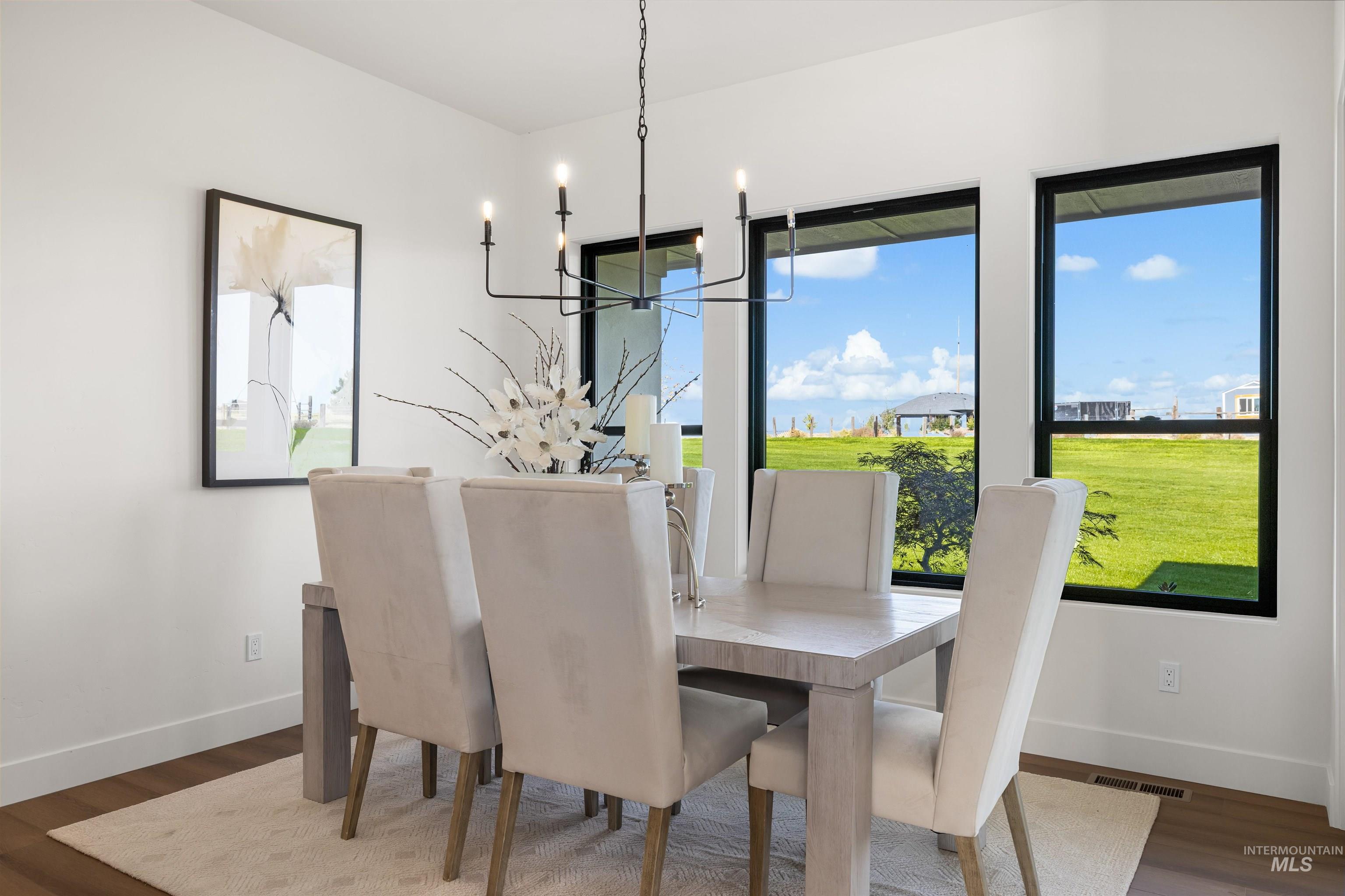25403 Bur Oak Place Caldwell, ID 83607 - Photo 18 of 46 Dining space featuring dark wood-style flooring and a chandelier