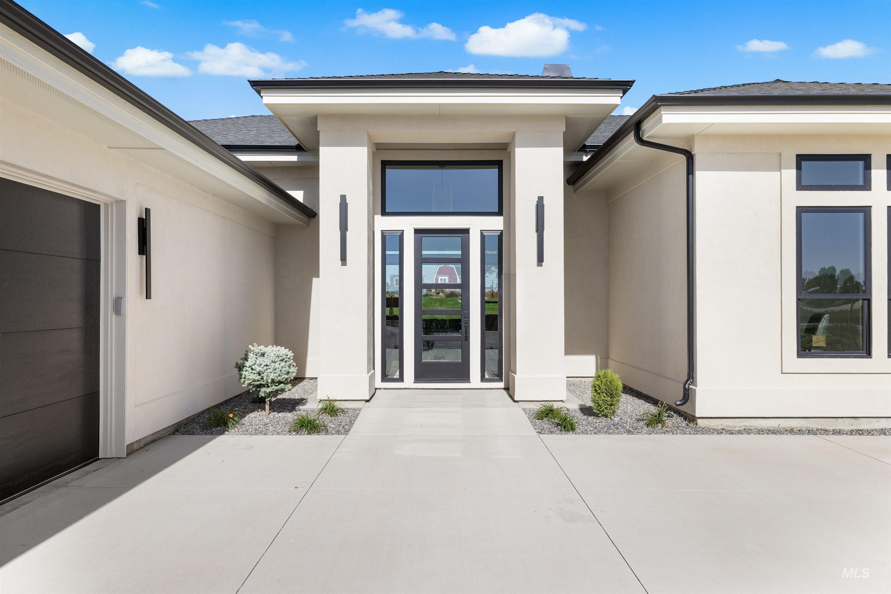 25403 Bur Oak Place Caldwell, ID 83607 - Photo 2 of 46 View of exterior entry featuring stucco siding and roof with shingles