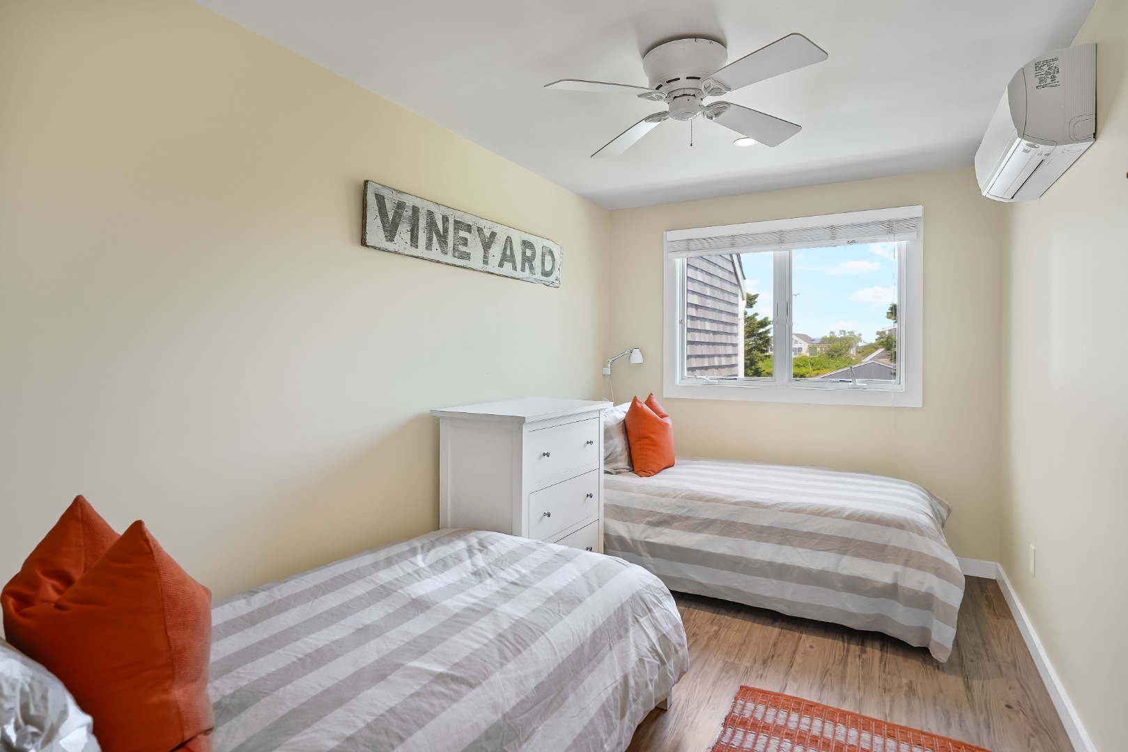 493 Katama Road, Unit E2 Edgartown, MA 02539 - Photo 13 of 29 a bedroom with a bed and a chandelier