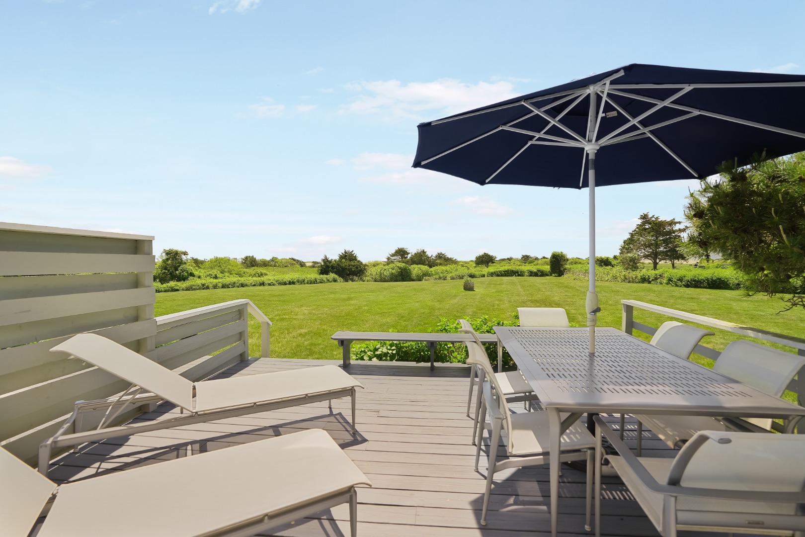 493 Katama Road, Unit E2 Edgartown, MA 02539 - Photo 18 of 29 an outdoor sitting area with furniture and umbrella