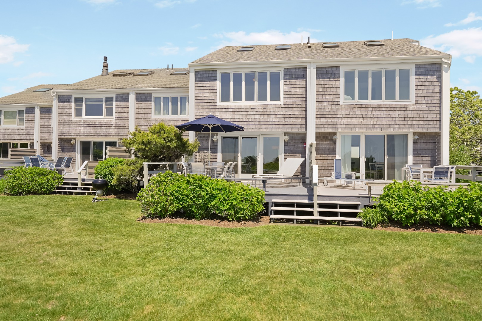 493 Katama Road, Unit E2 Edgartown, MA 02539 - Photo 22 of 29 a front view of a house with a yard