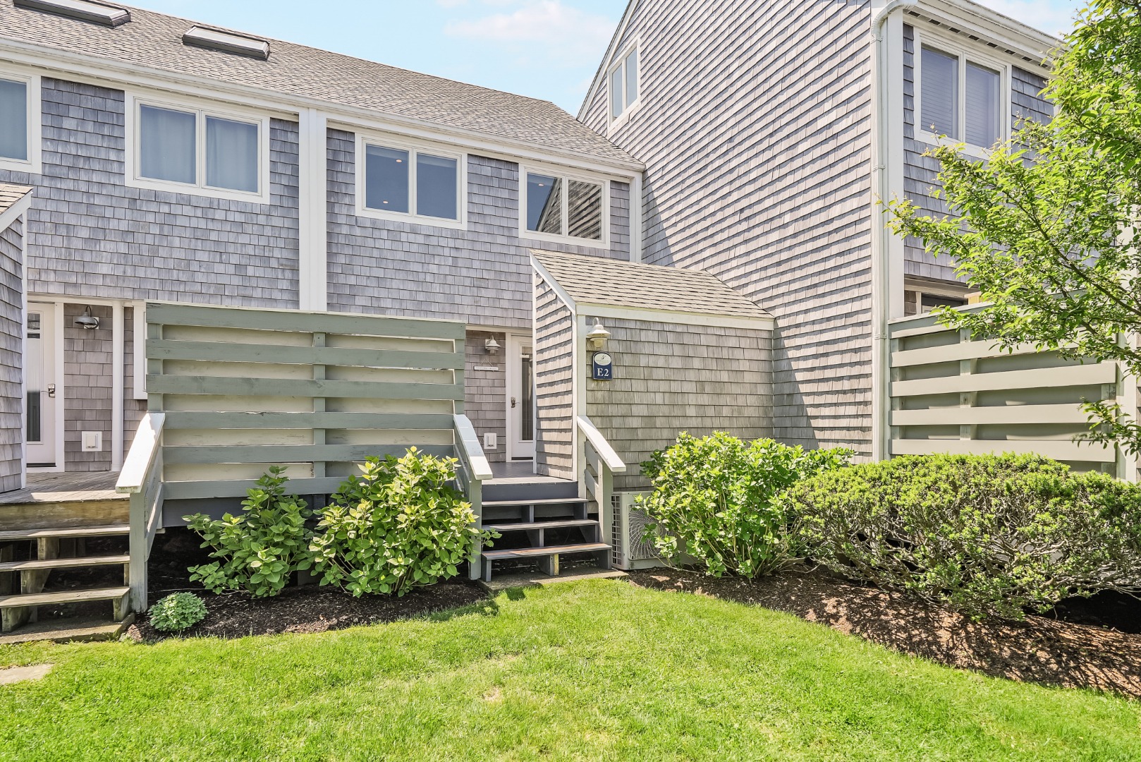 493 Katama Road, Unit E2 Edgartown, MA 02539 - Photo 23 of 29 a view of backyard with potted plants and a chair