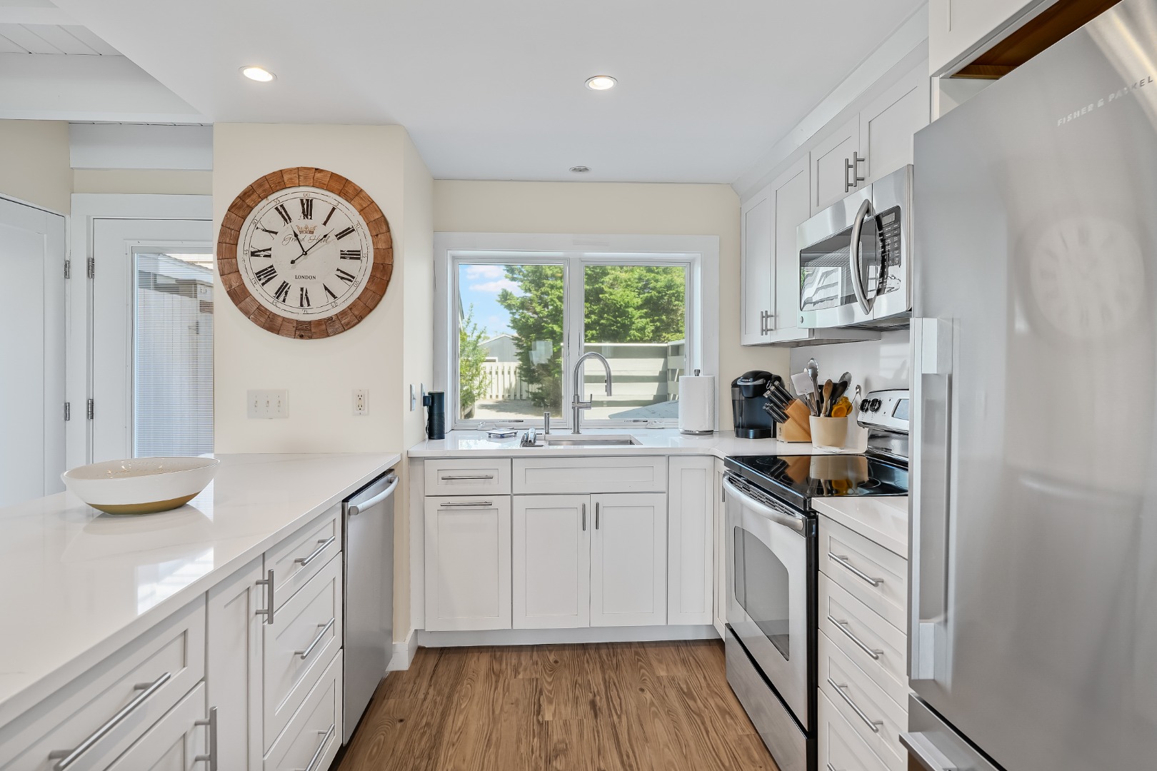 493 Katama Road, Unit E2 Edgartown, MA 02539 - Photo 6 of 29 a kitchen with a sink cabinets and a large window
