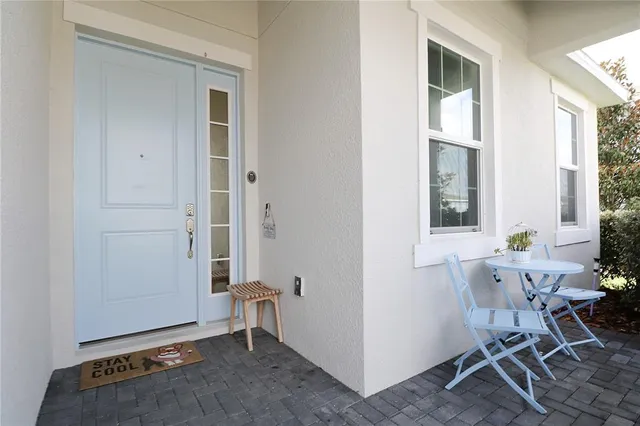 a view of a room that has a window and furniture
