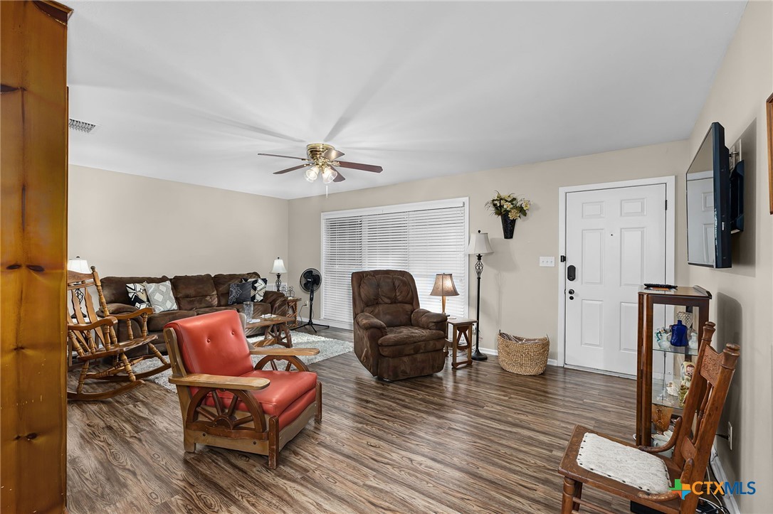 2052 Gruene Road New Braunfels, TX 78130 - Photo 11 of 33 a living room with furniture a fireplace and a flat screen tv
