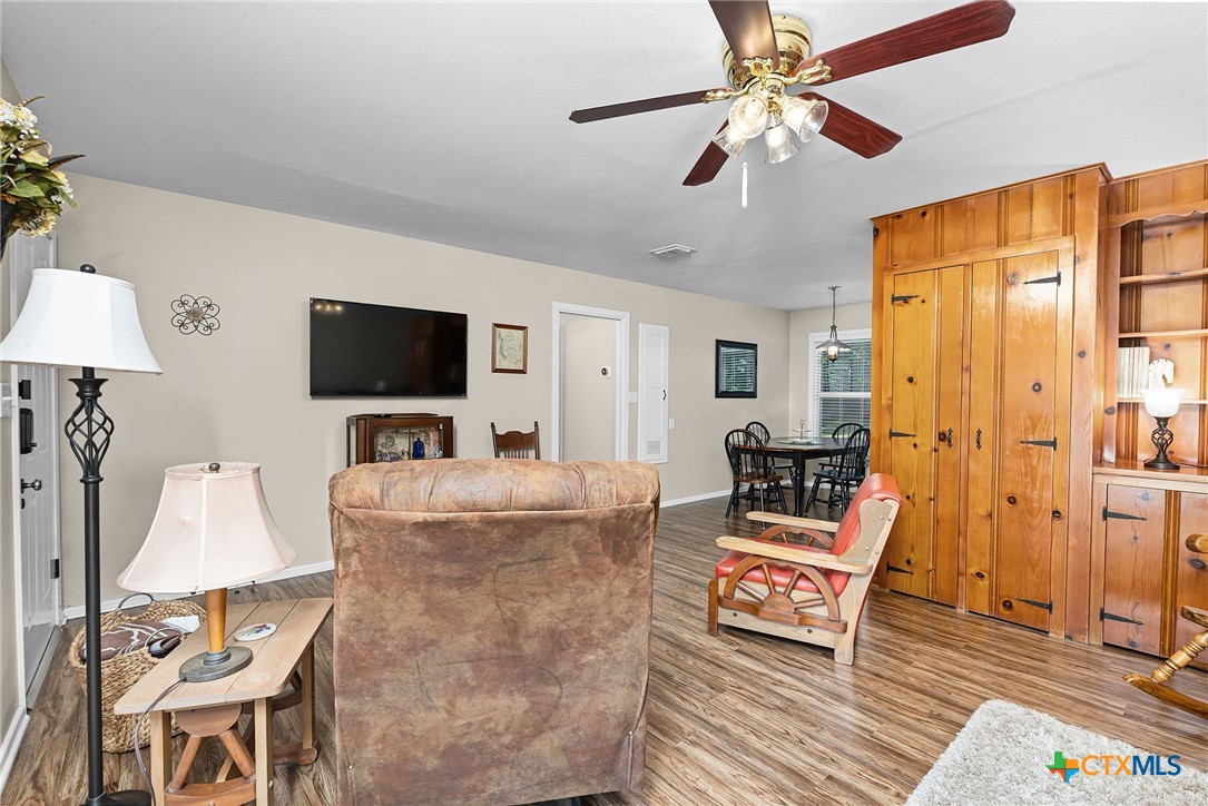 2052 Gruene Road New Braunfels, TX 78130 - Photo 12 of 33 a living room with furniture a flat screen tv and a fireplace